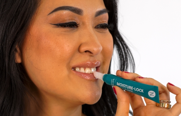 Woman placing Neora’s Moisture-Lock Lip Mask on her lips 