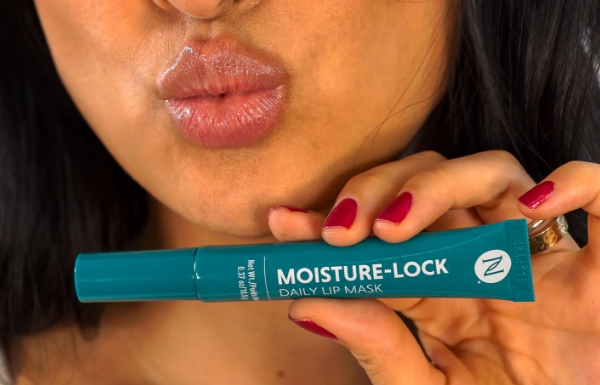 Woman holding Neora’s Moisture-Lock Lip Mask and doing a kissy face